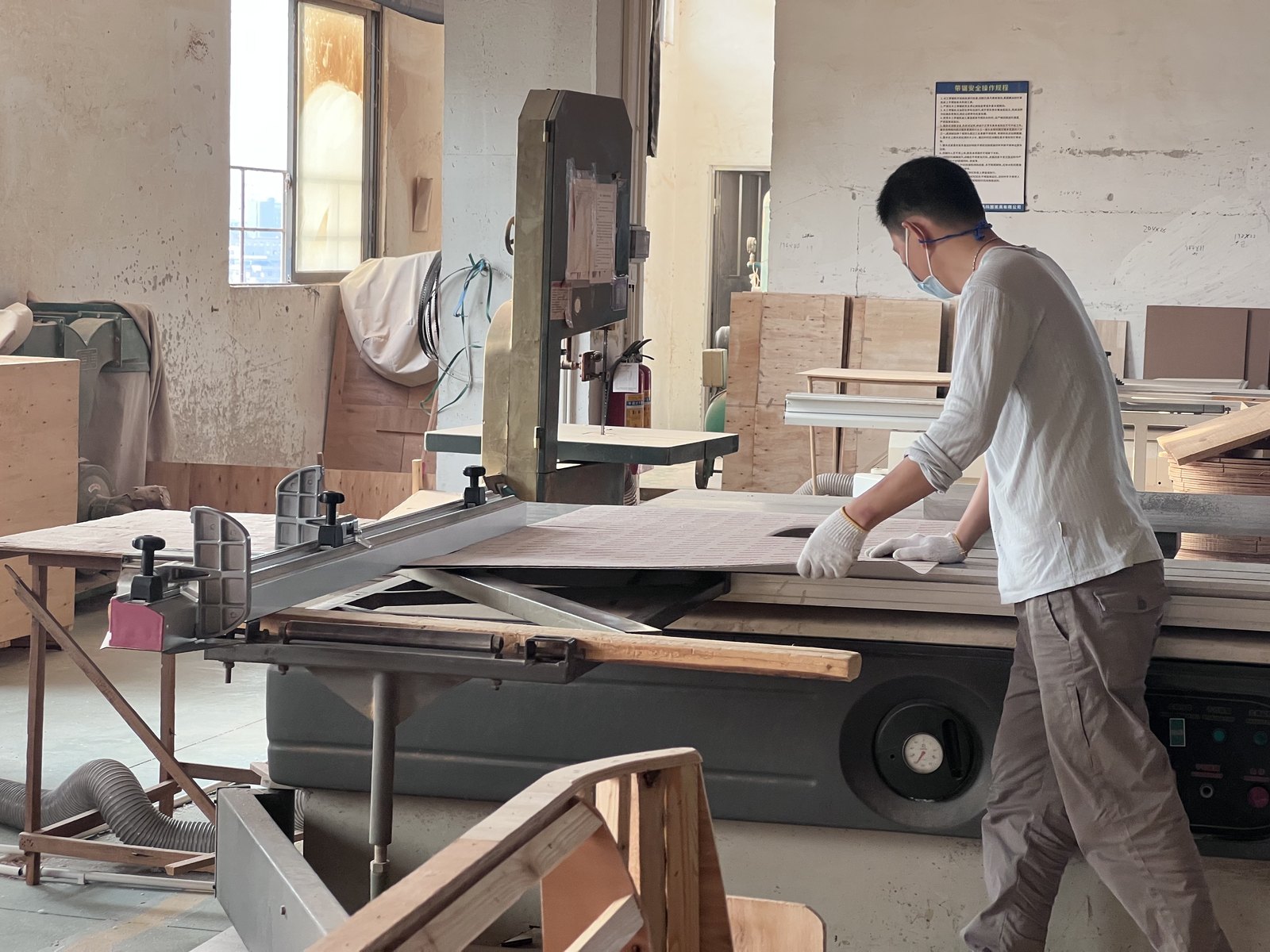 Craftsman cutting panels on the production floor of our Foshan furniture factory