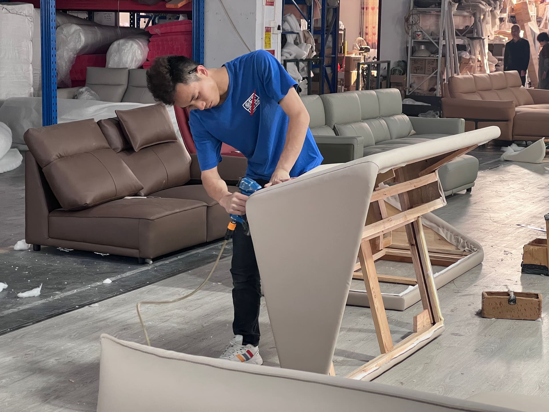 Upholsterer assembling a sofa frame